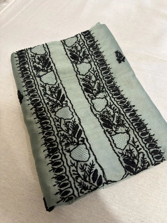 Folded Celadon Green Lucknowi Chikankari Chanderi Silk unstitched kurta fabric with elegant black hand embroidery.