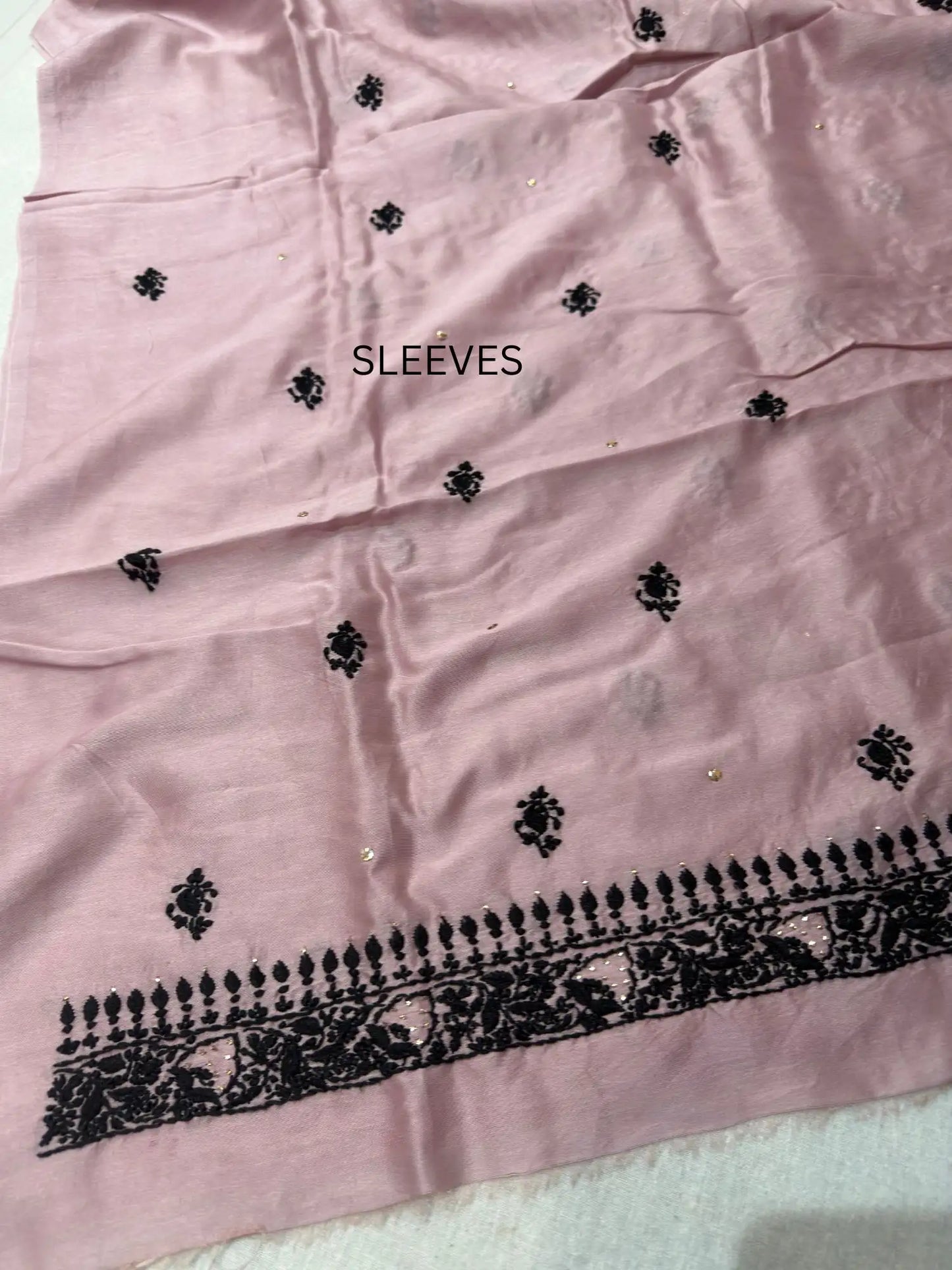 Fine Lucknowi Chikankari embroidery on the sleeve of Dusty Mauve linen kurta fabric.