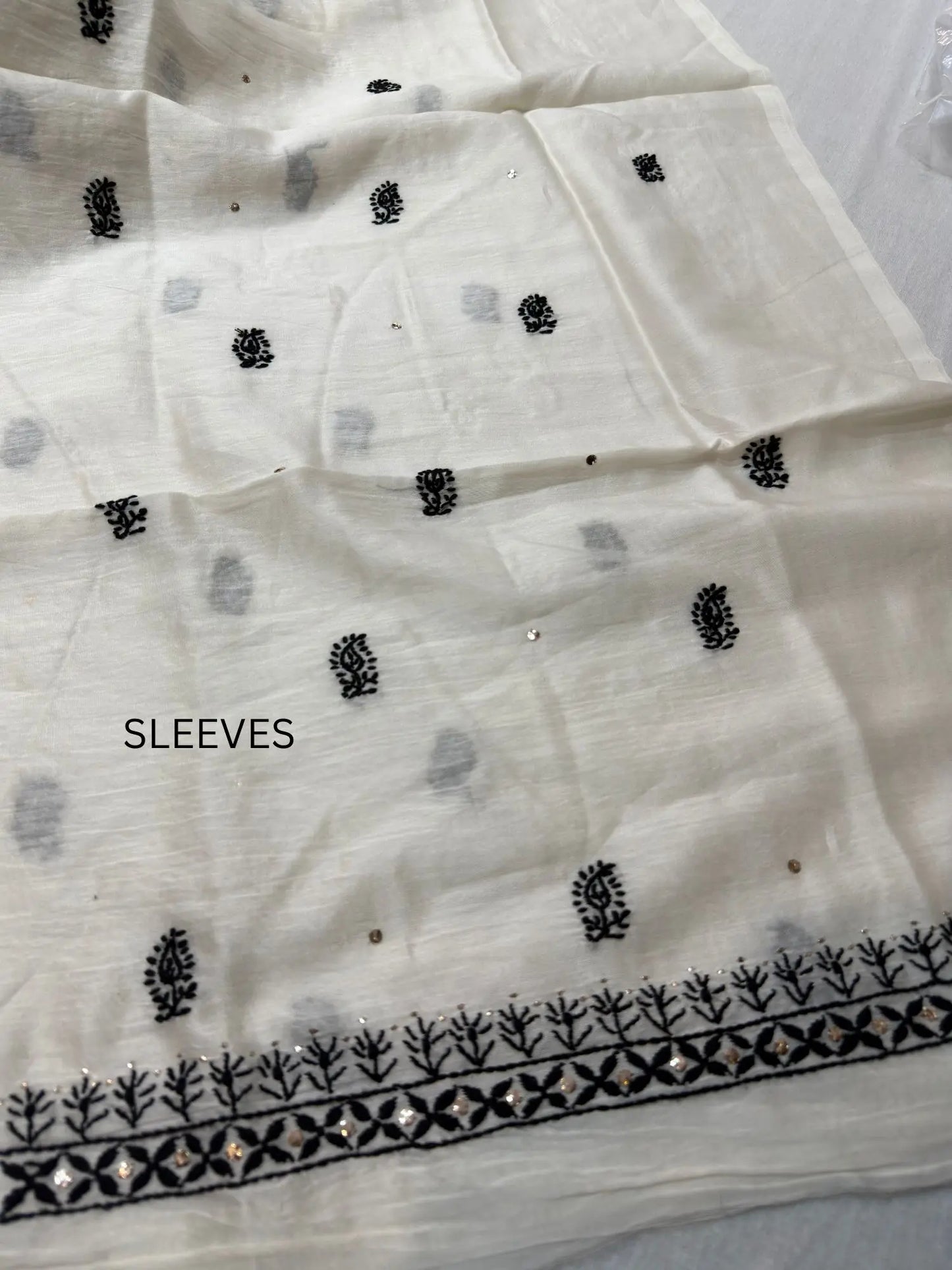 Fine Chikankari embroidery and hand Mukaish detailing on the sleeve of Ivory White Chanderi Silk kurta fabric.