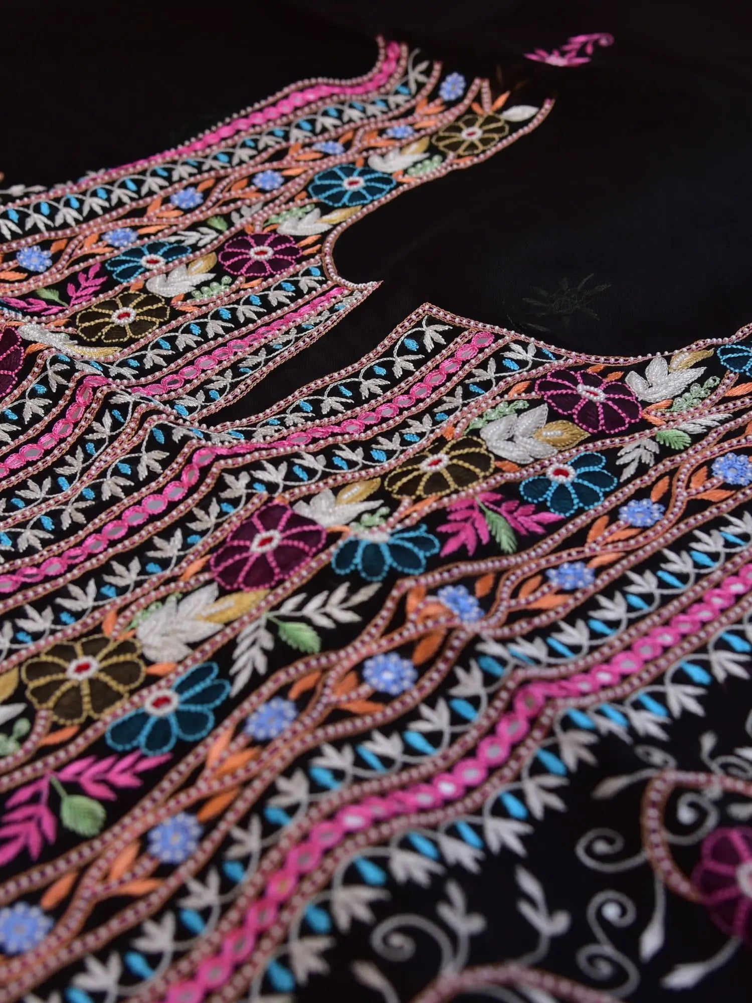 Close-up of black Pure Organza Silk suit with multicolour floral embroidery and pearl detailing