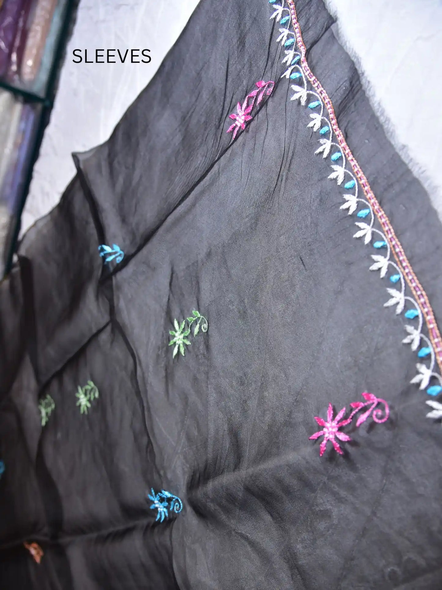 Full sleeve detail of black Pure Organza Silk suit with multicolour floral Parsi Shadow embroidery