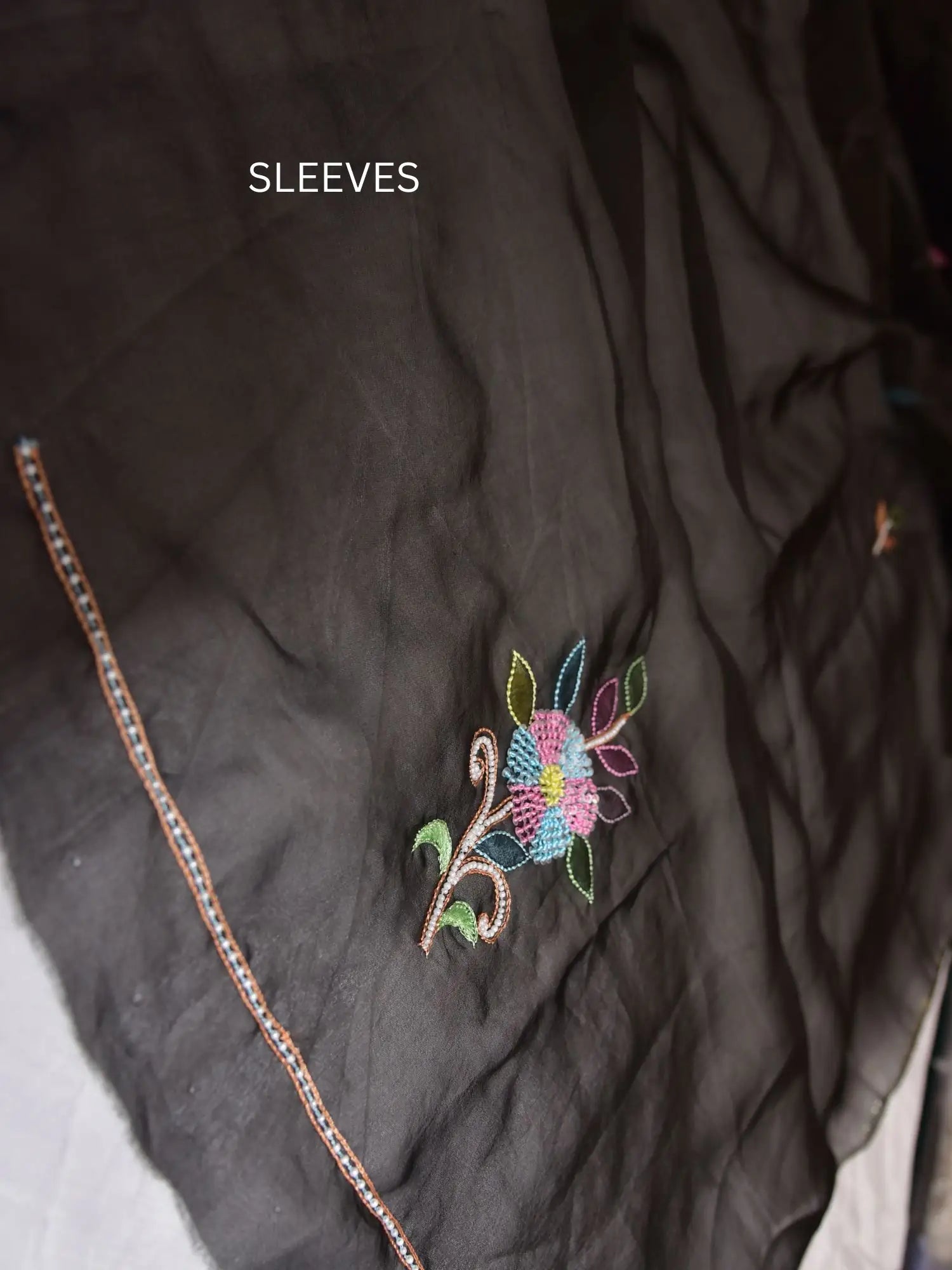 Sleeve detail of black Pure Organza Silk suit with multicolour floral Parsi Shadow embroidery