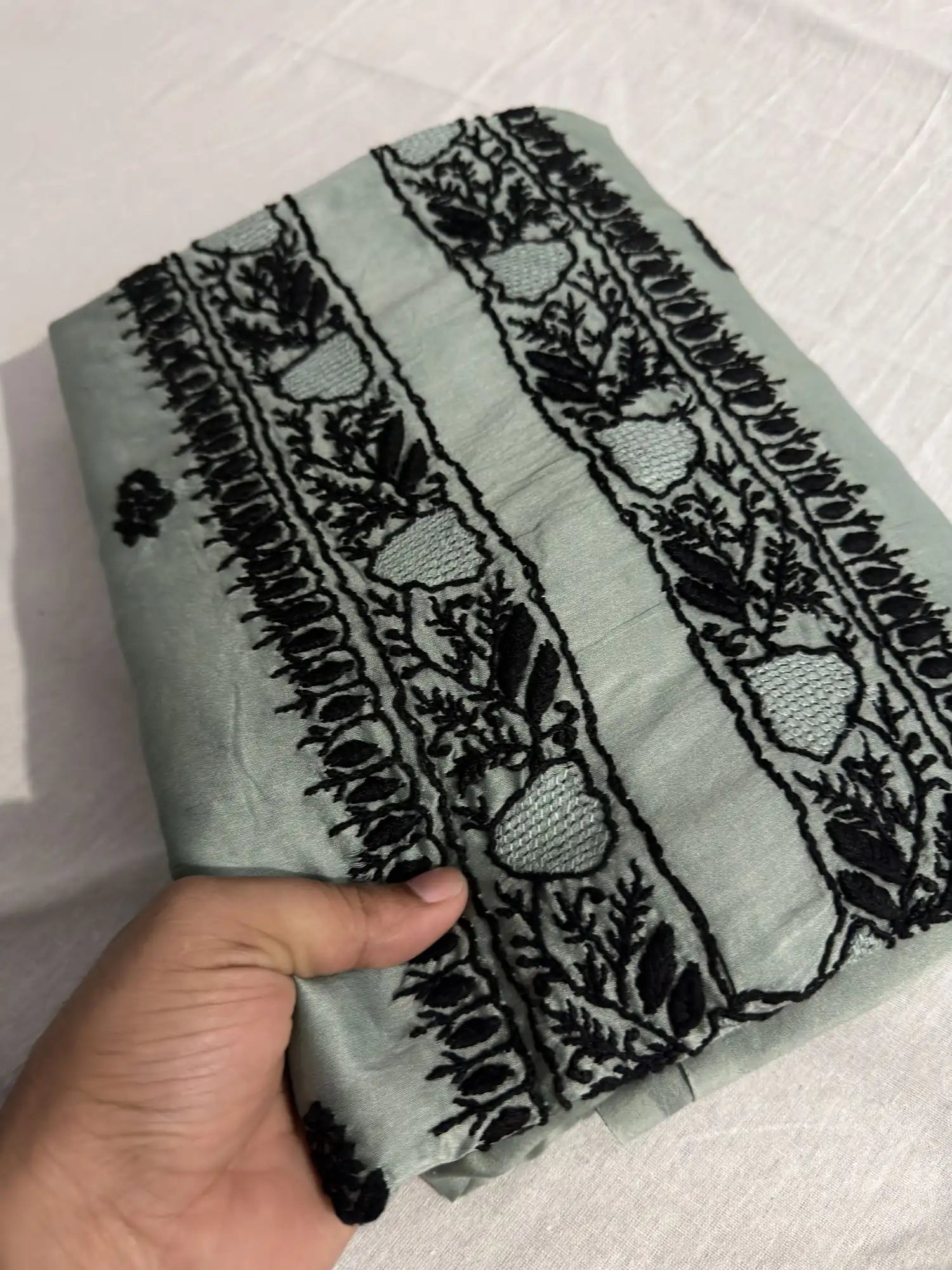 Premium Celadon Green Chanderi Silk Lucknowi Chikankari unstitched kurta fabric shown in folded view.