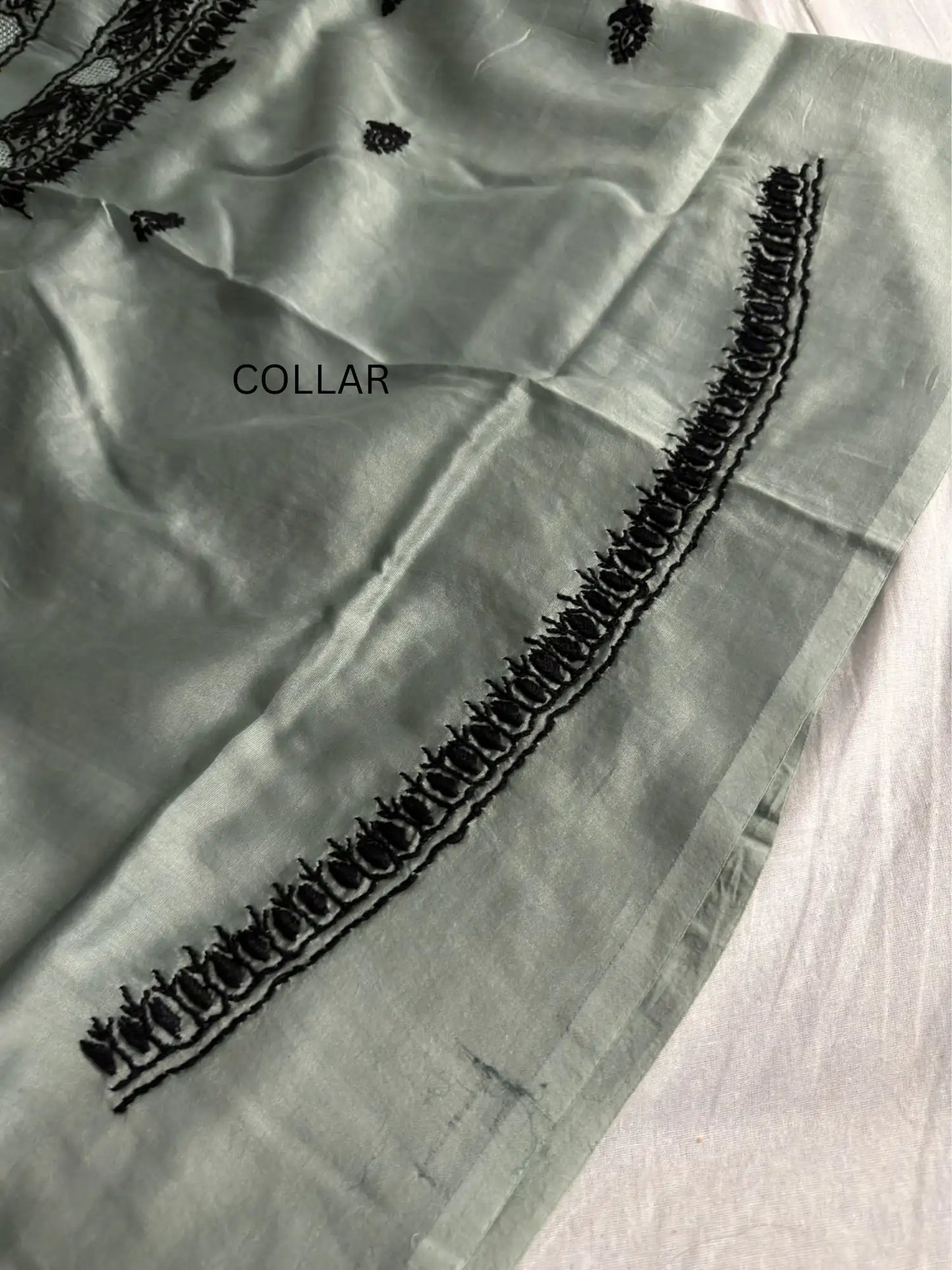 Intricate black Lucknowi Chikankari embroidery on the collar of Celadon Green Chanderi Silk unstitched kurta fabric.