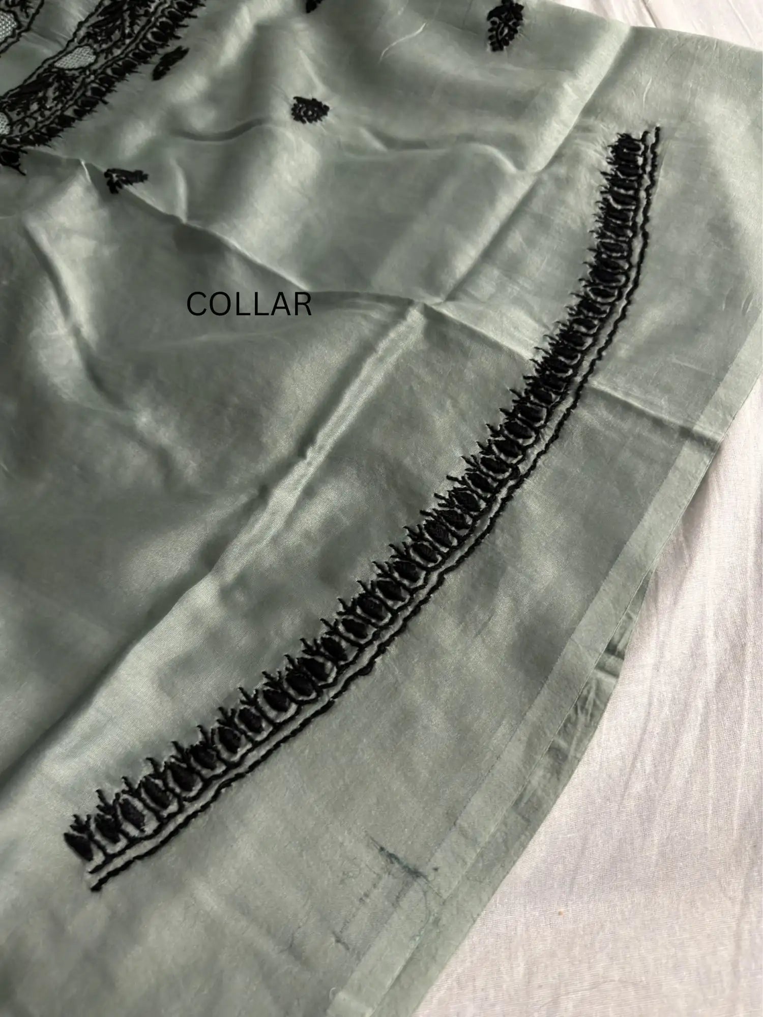 Intricate black Lucknowi Chikankari embroidery on the collar of Celadon Green Chanderi Silk unstitched kurta fabric.