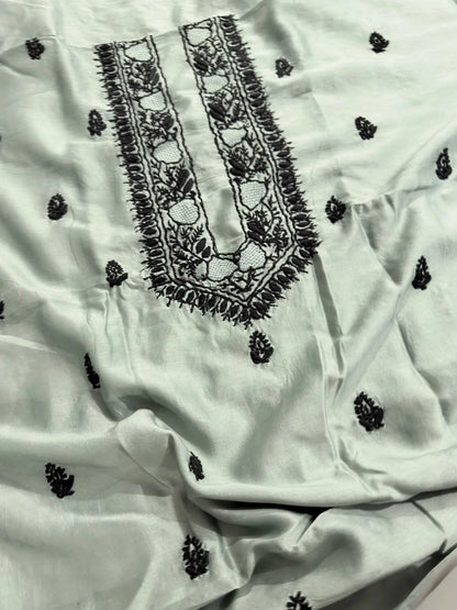 Intricate black Lucknowi Chikankari embroidery on the neckline of Celadon Green Chanderi Silk unstitched kurta fabric.