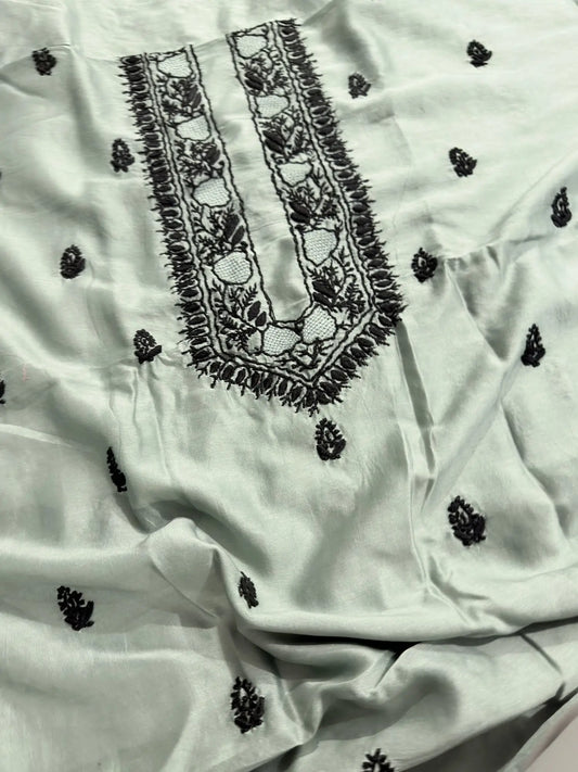 Intricate black Lucknowi Chikankari embroidery on the neckline of Celadon Green Chanderi Silk unstitched kurta fabric.