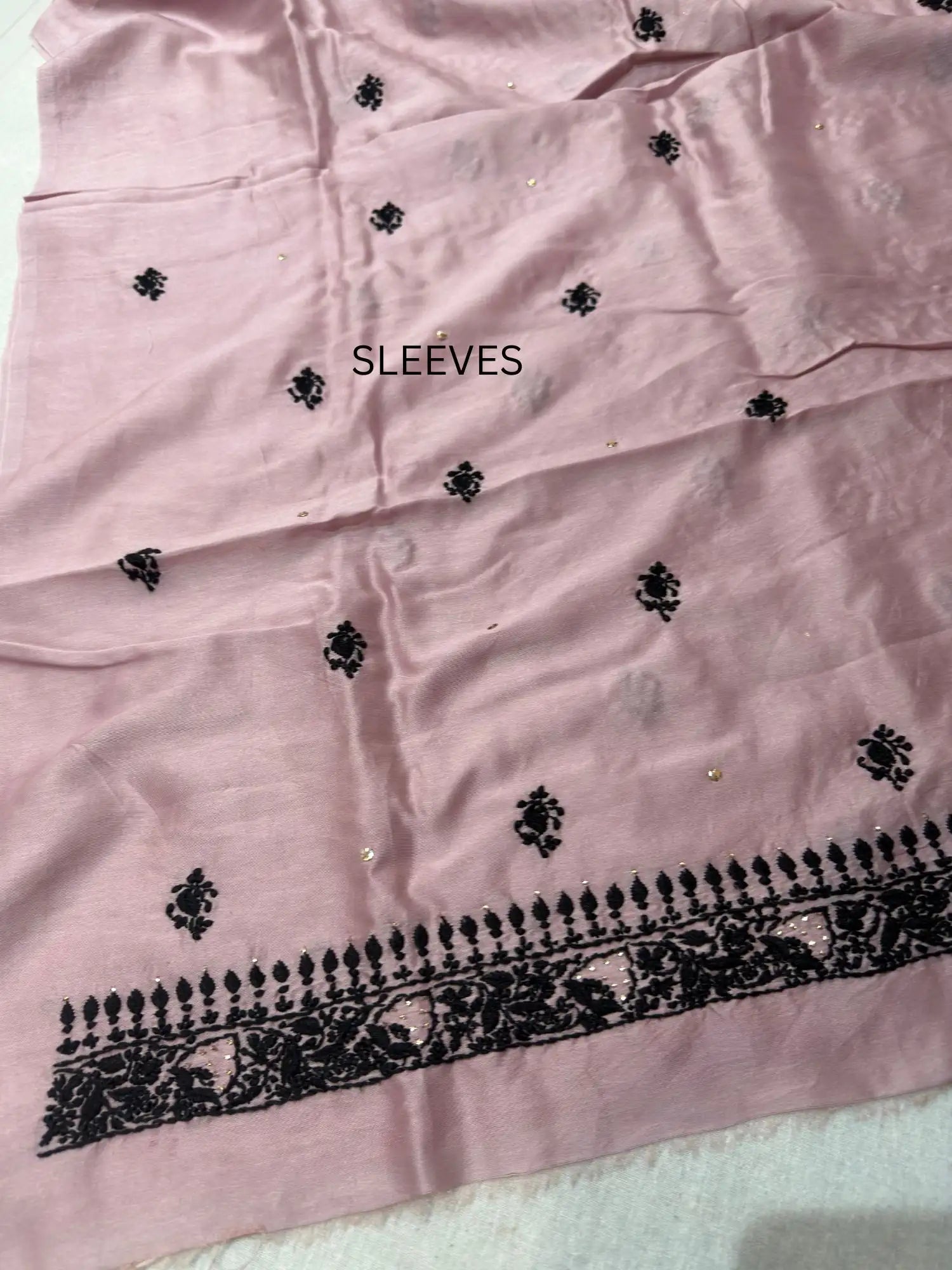 Fine Lucknowi Chikankari embroidery on the sleeve of Dusty Mauve linen kurta fabric.