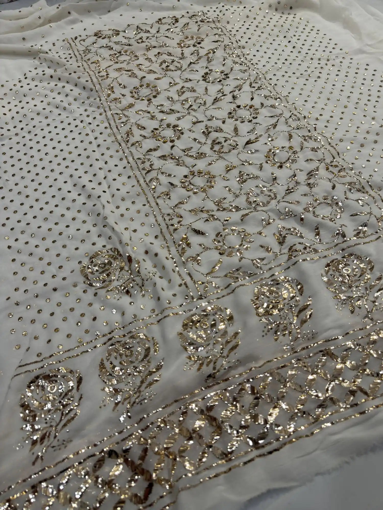 Floral Badla and Mukaish embroidered border detail on an off white Lucknowi Kurta Set