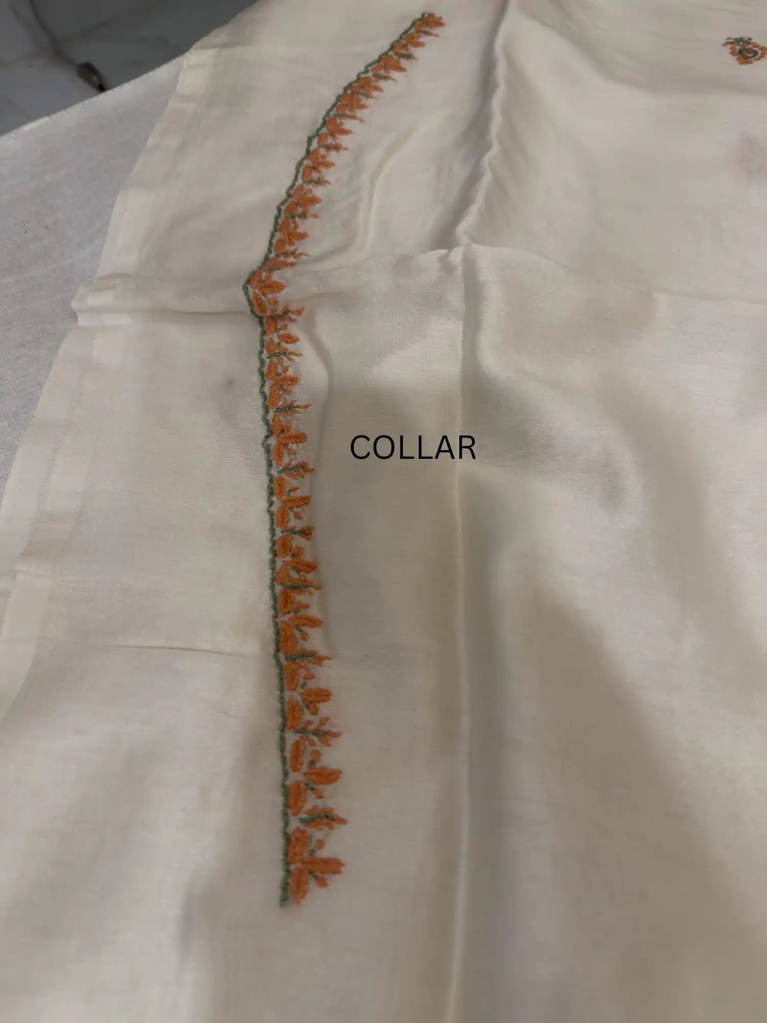 Handcrafted peach and sage green Lucknowi Chikankari collar embroidery on premium ivory Chanderi Silk unstitched kurta fabric.