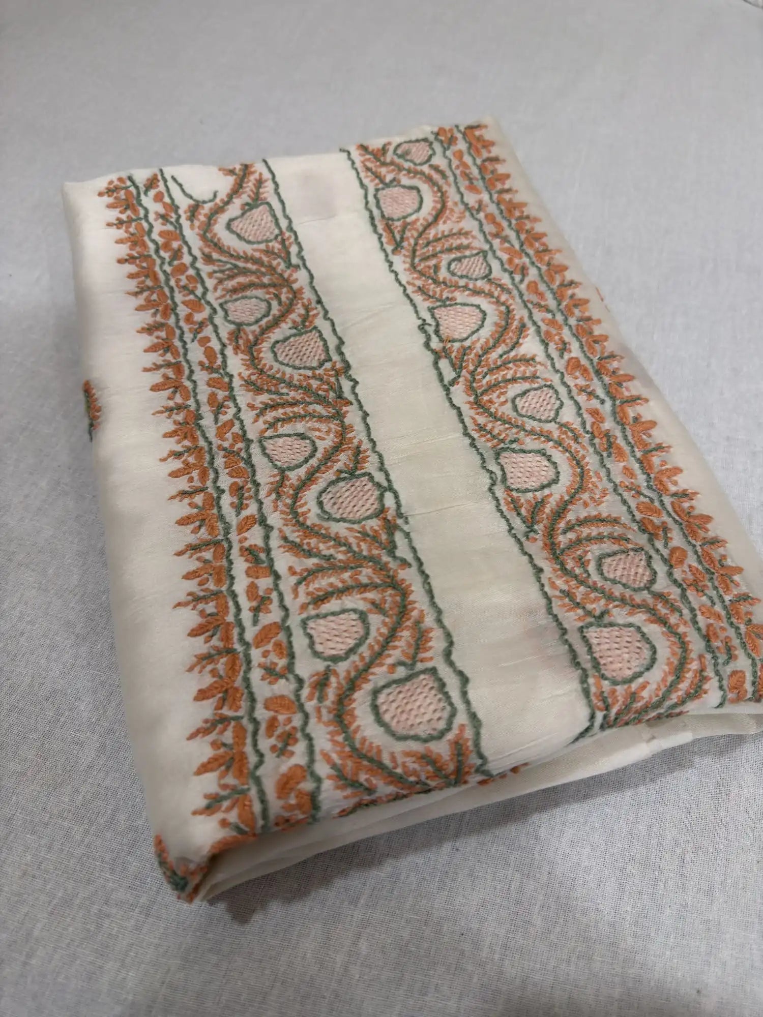 Close-up of premium ivory dyeable Chanderi Silk fabric highlighting authentic Lucknowi Chikankari embroidery and fine woven texture.