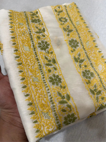Close-up of mustard yellow and olive green Lucknowi Chikankari embroidery of ivory dyeable Chanderi Silk fabric.