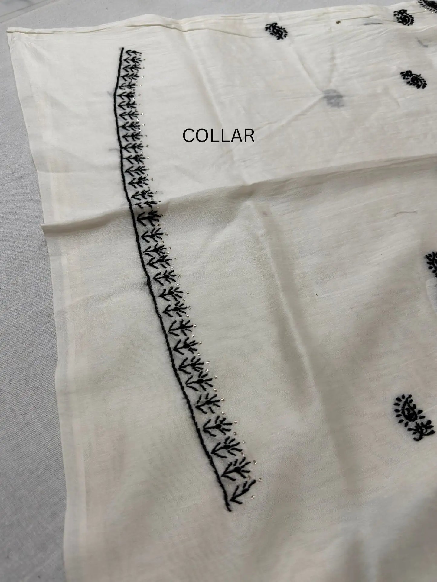 Detailed Chikankari embroidery and hand Mukaish work on the collar of Ivory White Chanderi Silk kurta fabric.
