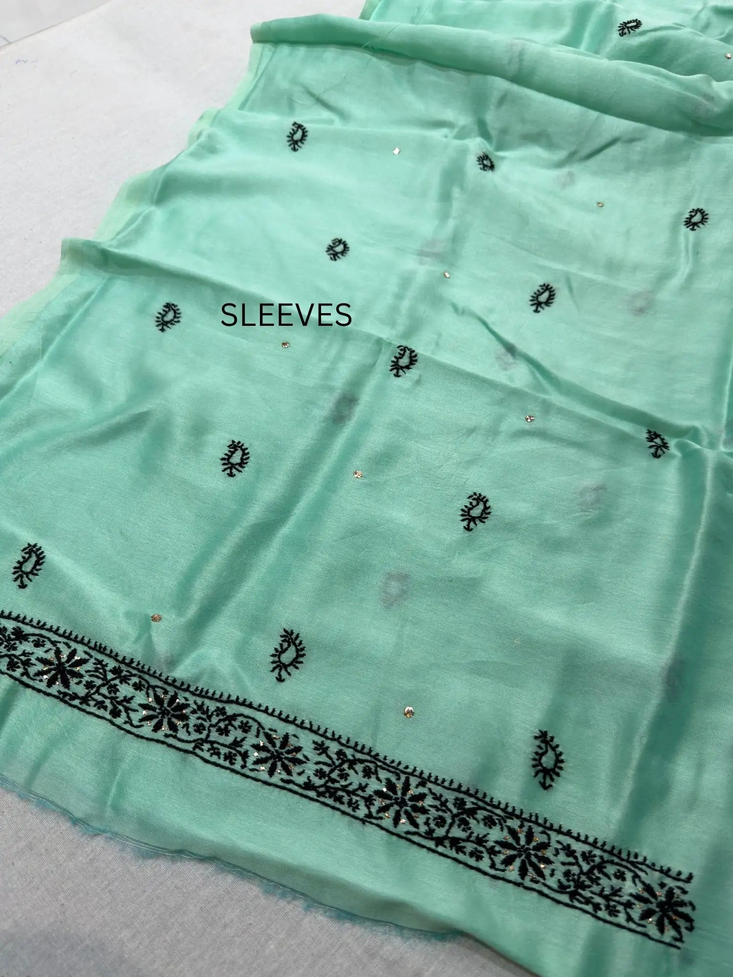 Fine white Lucknowi Chikankari embroidery and hand Mukaish work on Lavender Mist Chanderi Silk sleeve fabric.