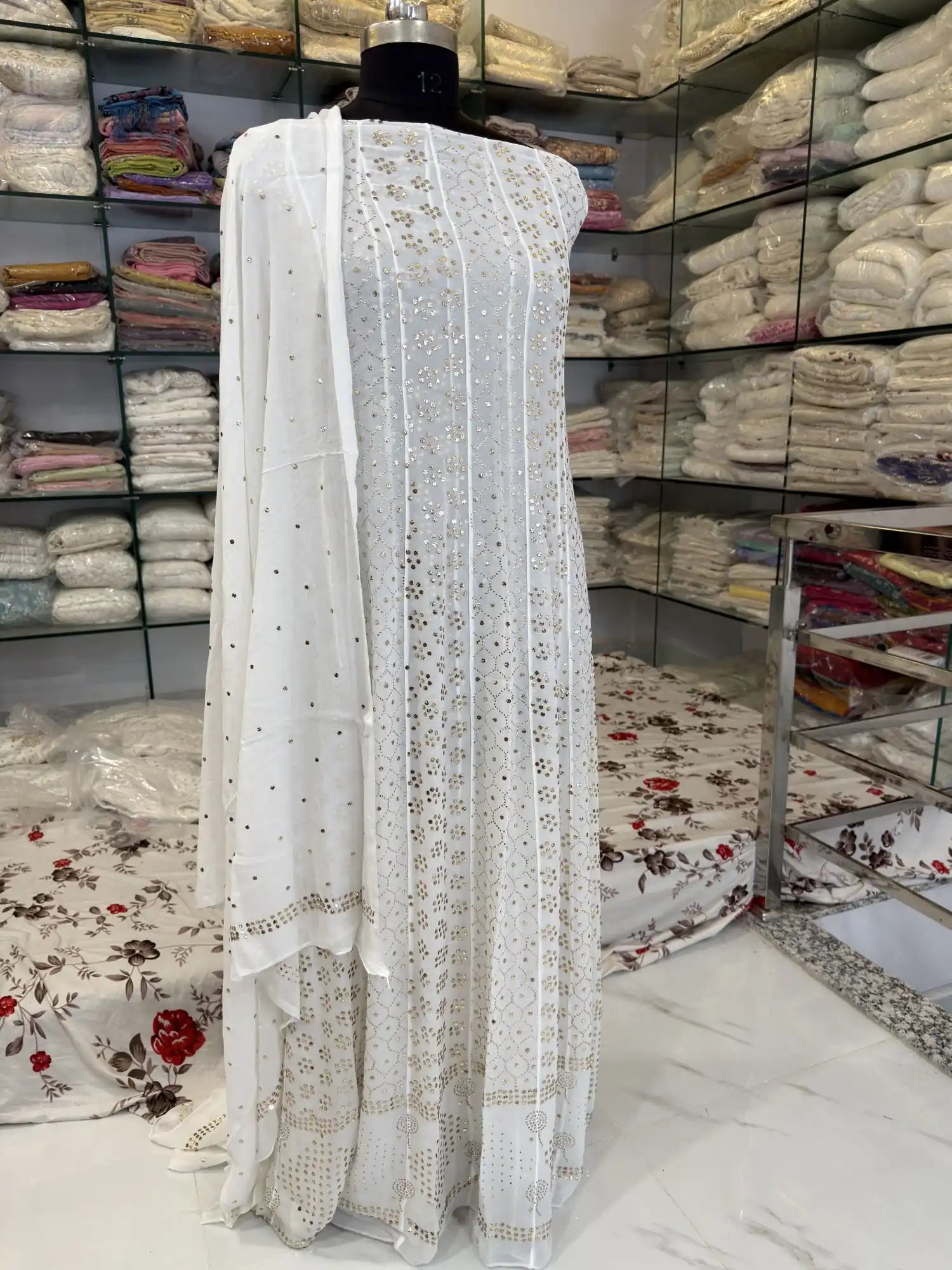 Front view of Lucknowi Chikankari Viscose Georgette Anarkali with all-
over gold-toned Mukaish handwork