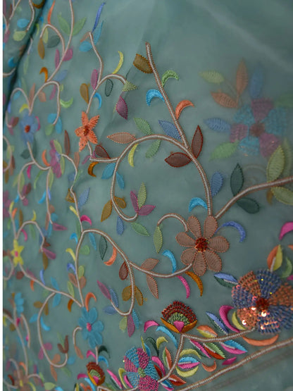 Close-up of mint green Pure Organza Silk suit with multicolour floral embroidery and pearl detailing
