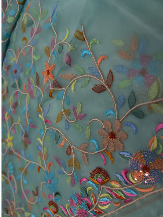 Close-up of mint green Pure Organza Silk suit with multicolour floral embroidery and pearl detailing