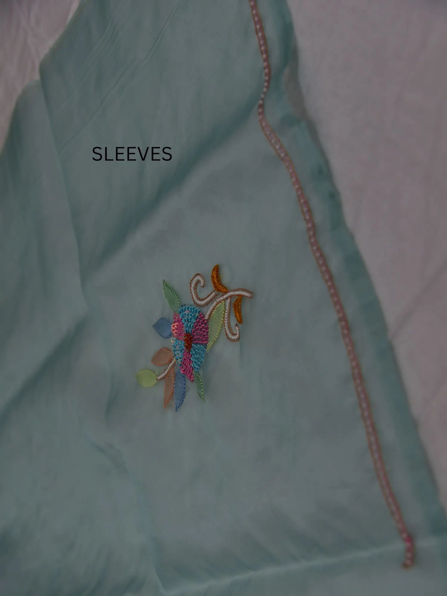 Full sleeve detail of mint green Pure Organza Silk suit with floral Parsi Shadow embroidery
