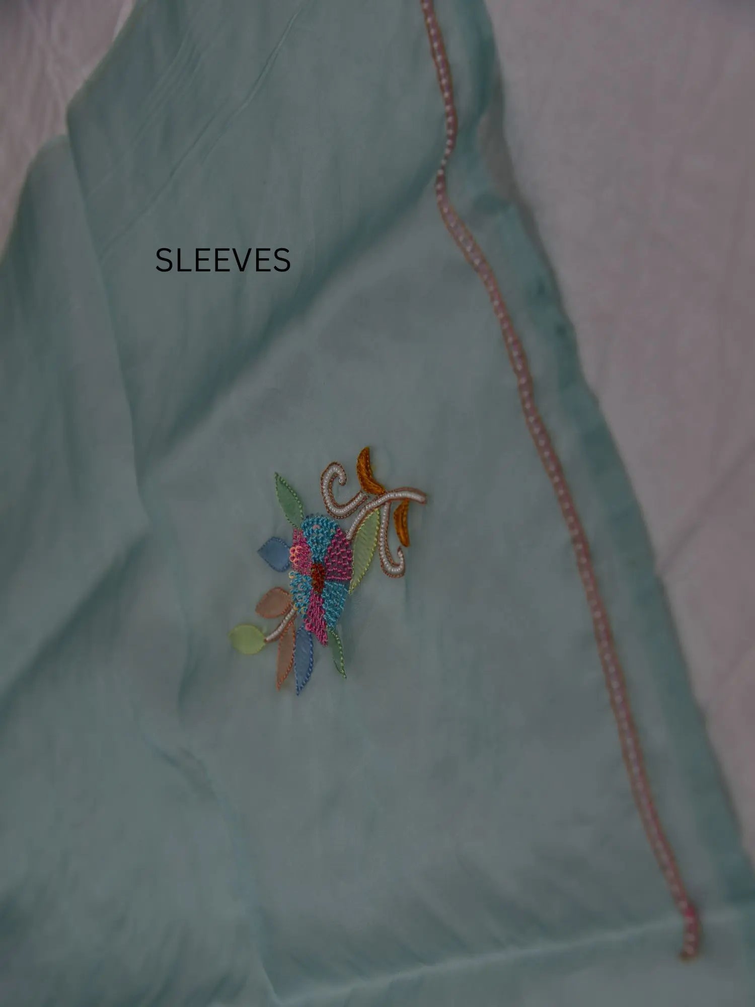 Full sleeve detail of mint green Pure Organza Silk suit with floral Parsi Shadow embroidery