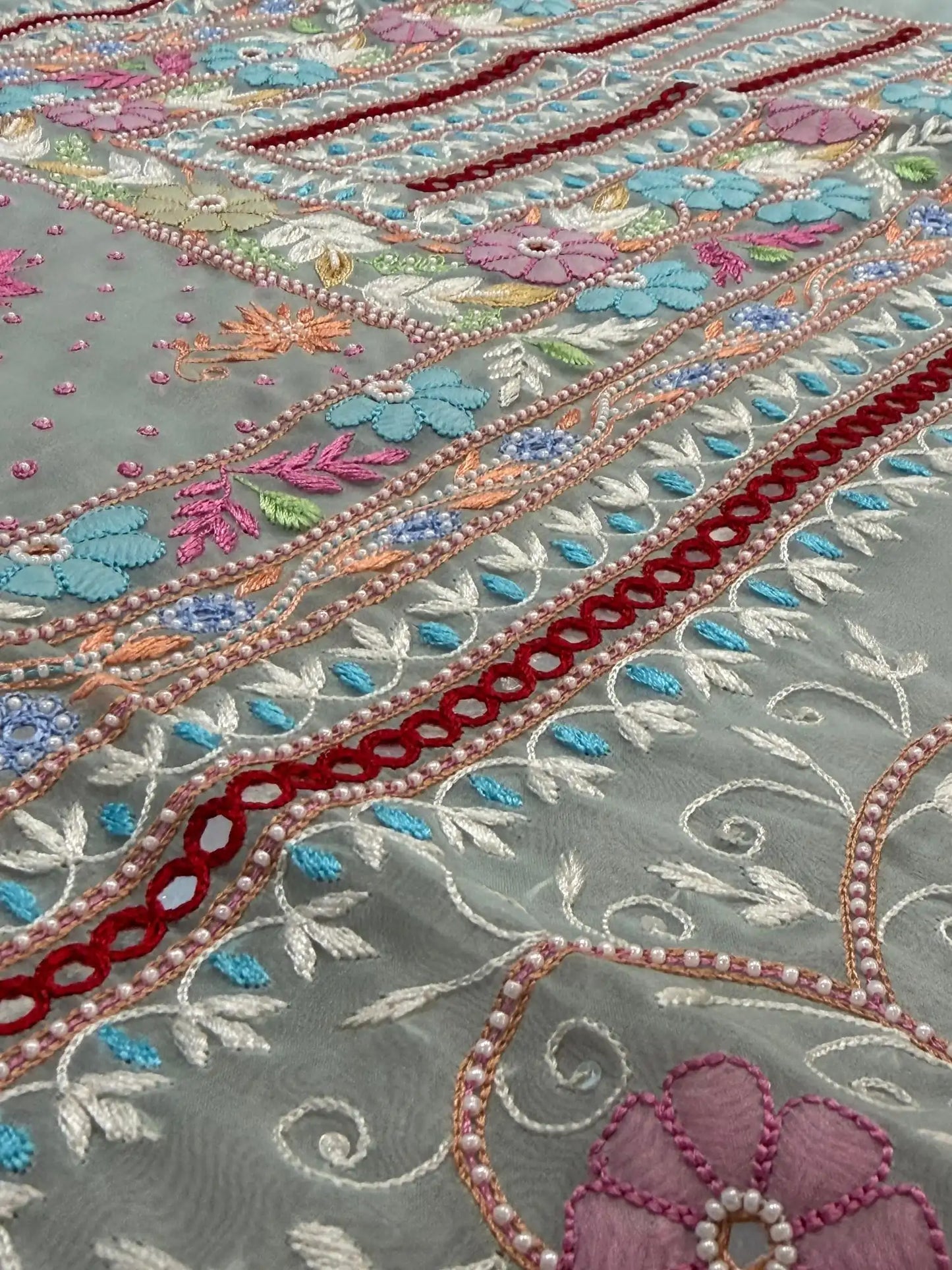 Close-up of pastel sea green Pure Organza suit with floral embroidery and pearl detailing