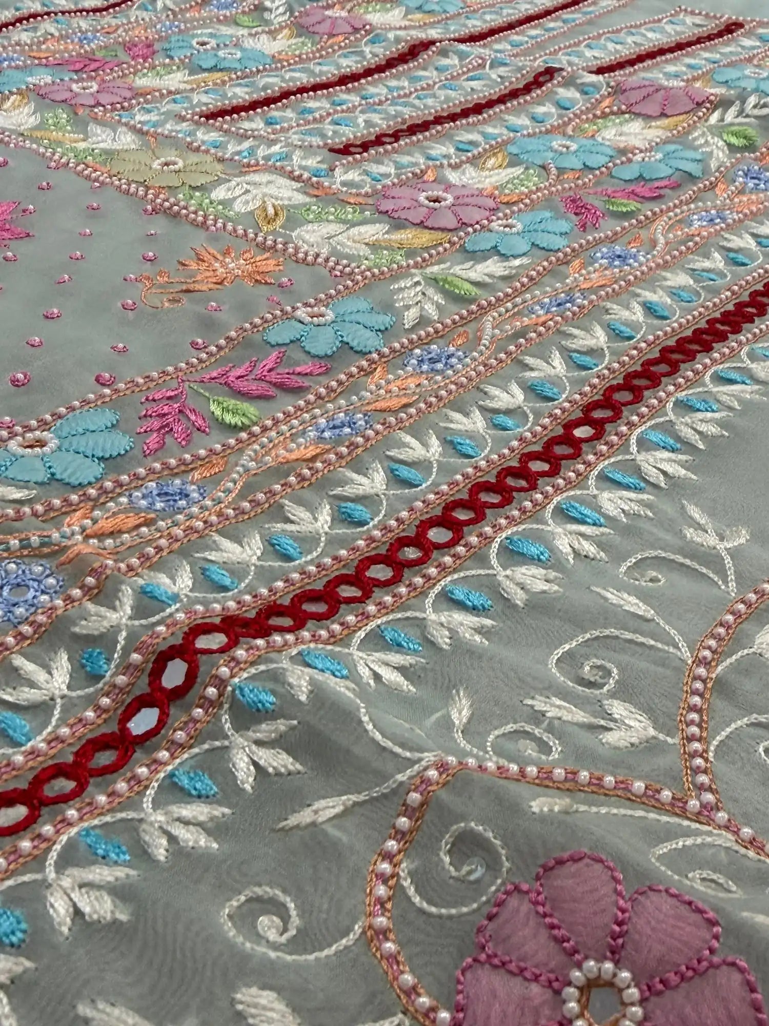 Close-up of pastel sea green Pure Organza suit with floral embroidery and pearl detailing