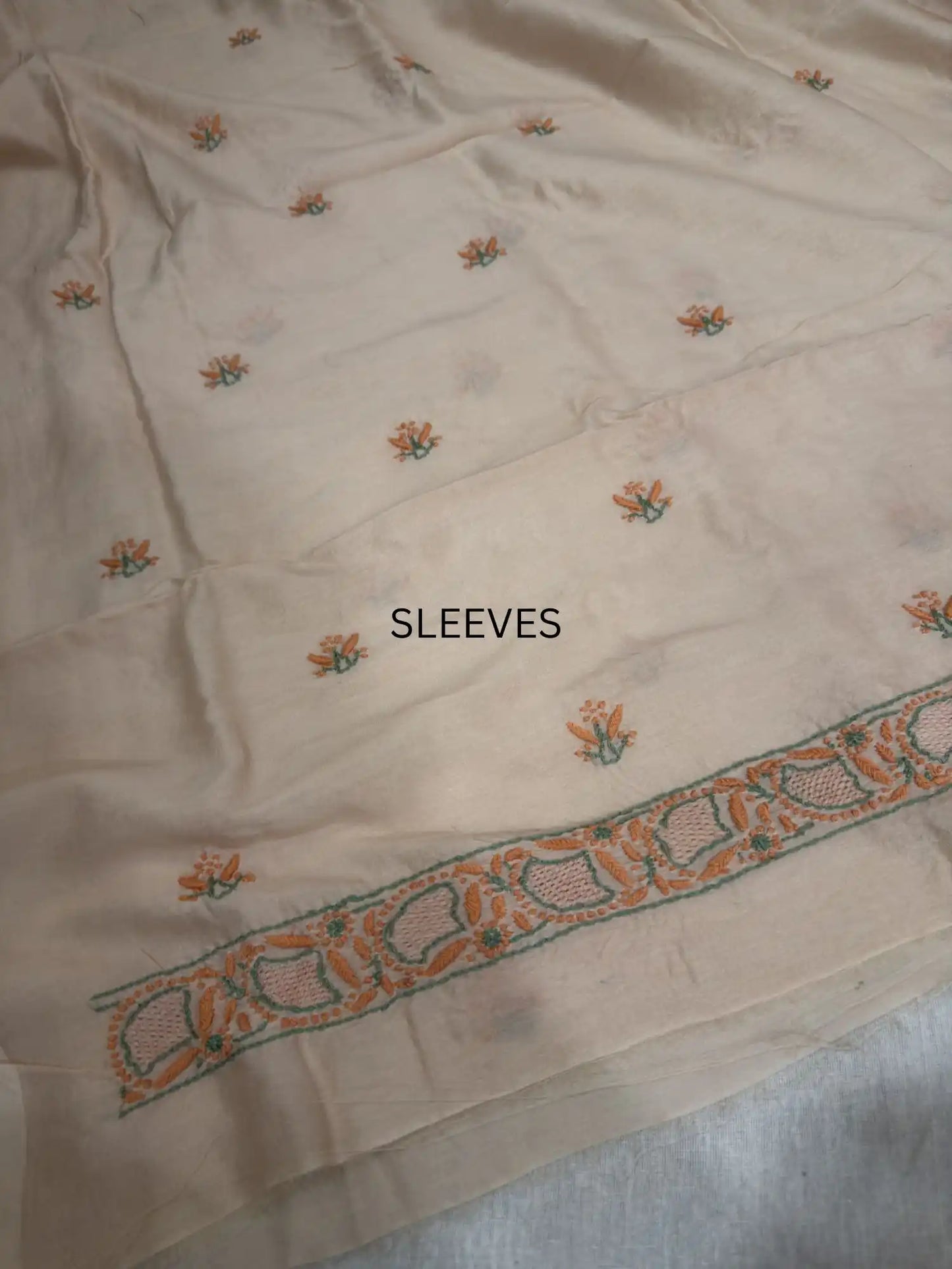 Fine peach and green Lucknowi Chikankari sleeve embroidery on Peach Blush Chanderi Silk kurta fabric.