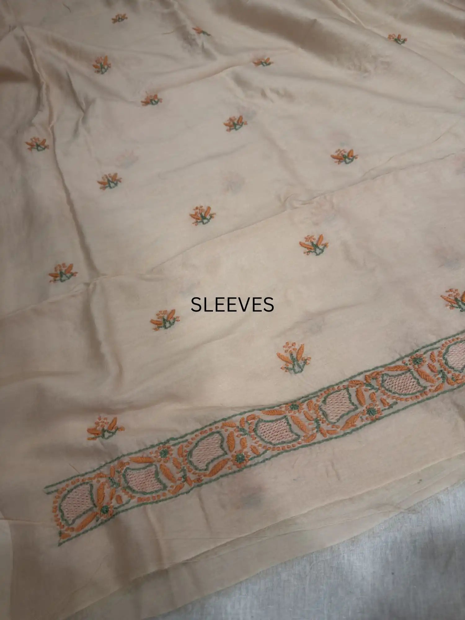 Fine peach and green Lucknowi Chikankari sleeve embroidery on Peach Blush Chanderi Silk kurta fabric.