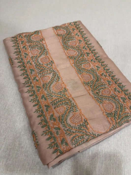 Intricate peach and green Lucknowi Chikankari embroidery of Peach Chanderi Silk kurta fabric.