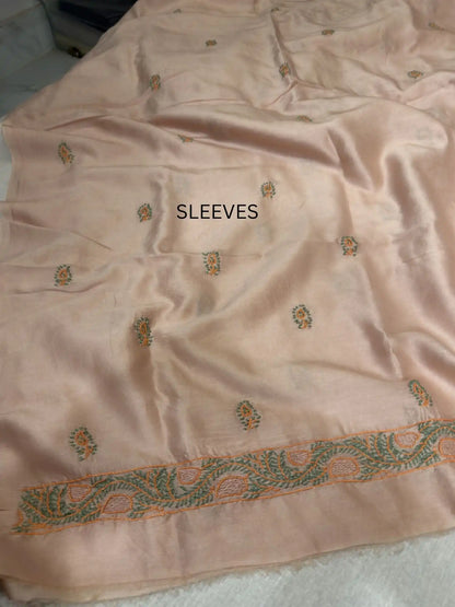 Elegant peach and green Chikankari sleeve embroidery on Peach Chanderi Silk kurta fabric.
