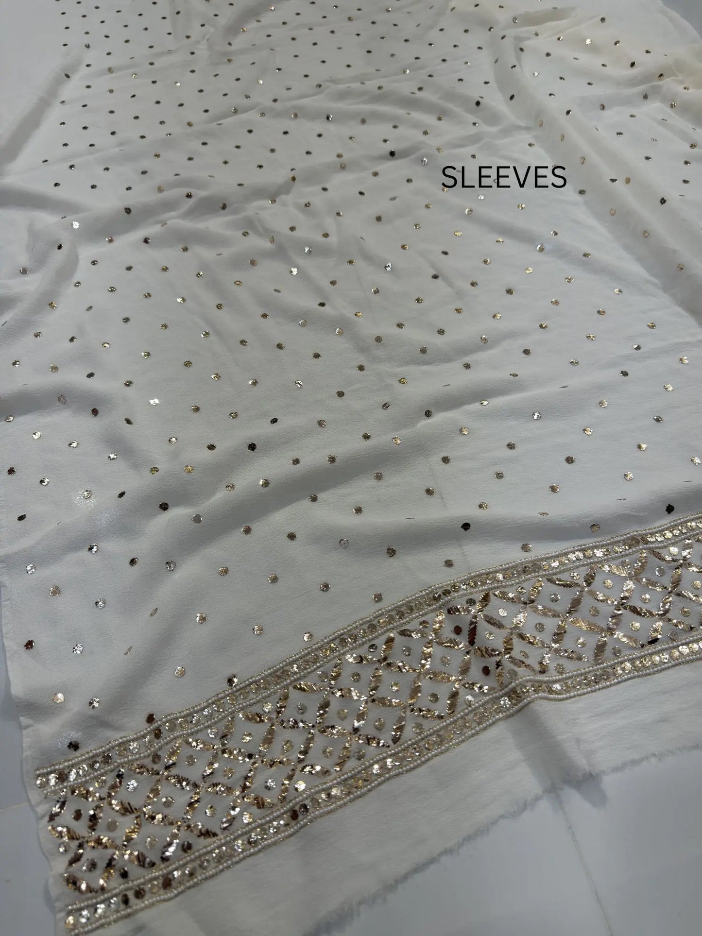 Handcrafted pearl, Badla and Mukaish border detail on a White Lucknowi Kurta Set Sleeves