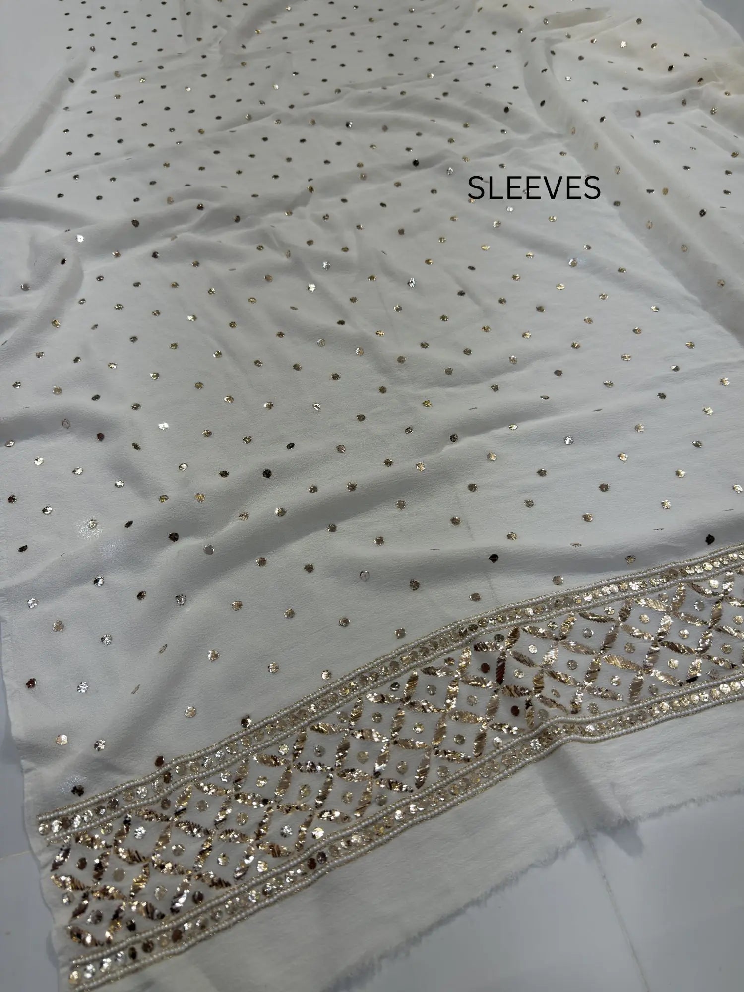 Handcrafted pearl, Badla and Mukaish border detail on a White Lucknowi Kurta Set Sleeves
