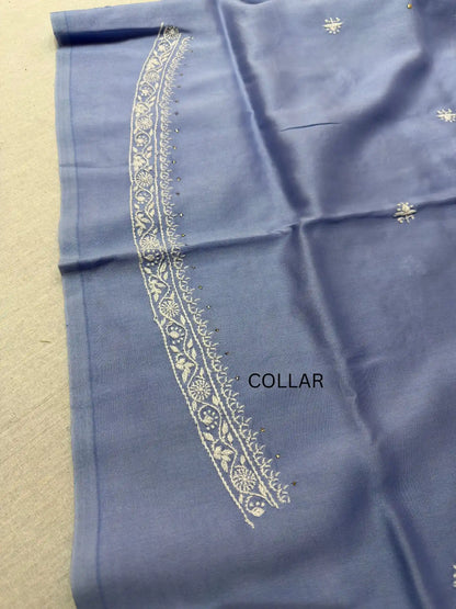 Detailed white Lucknowi Chikankari embroidery on the collar of Powder Blue linen kurta fabric.