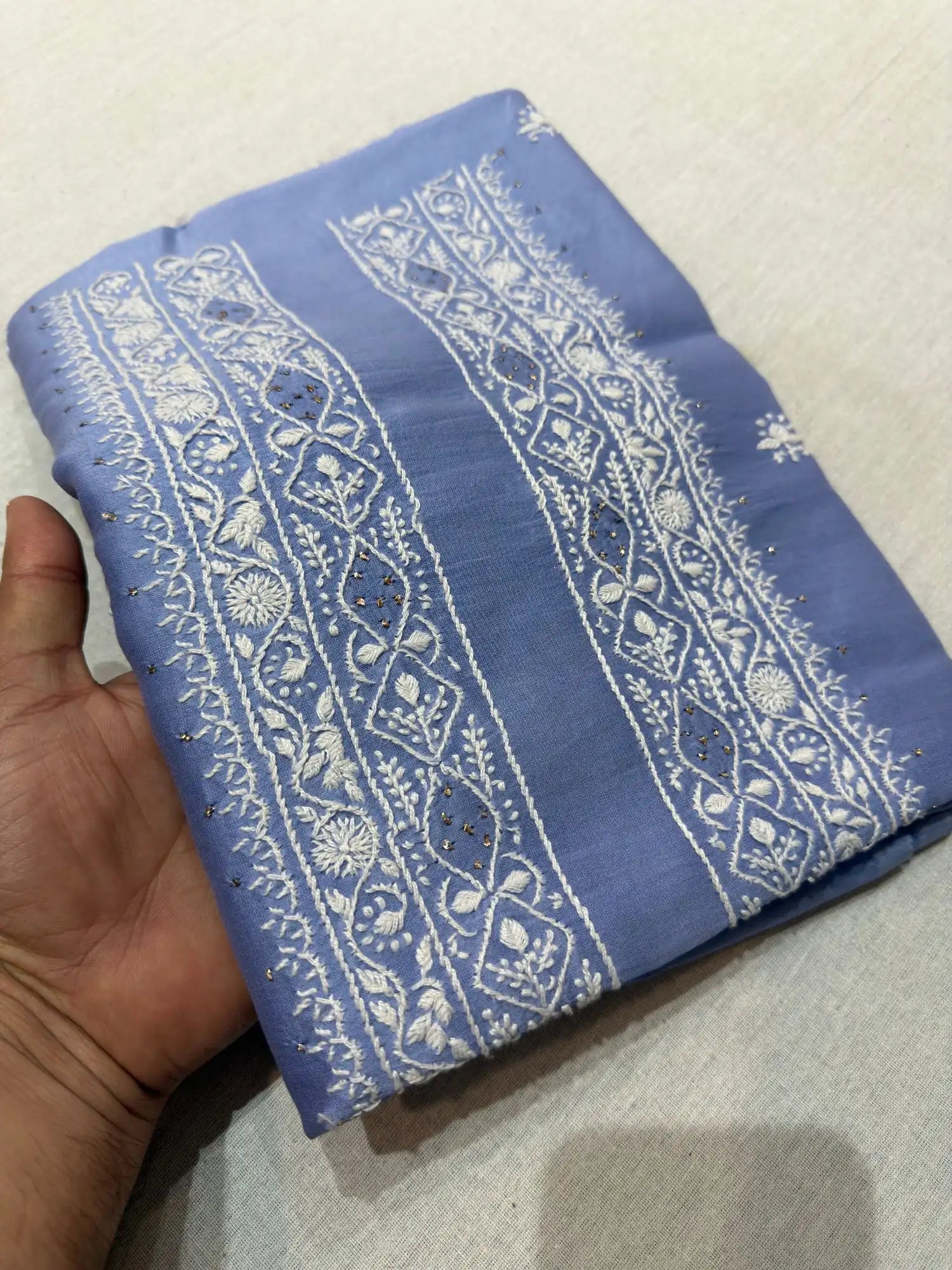 Front detail of Powder Blue linen Chikankari kurta fabric with elegant white embroidery.