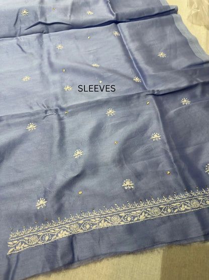Fine white Lucknowi Chikankari embroidery on the sleeve of Powder Blue linen kurta fabric.