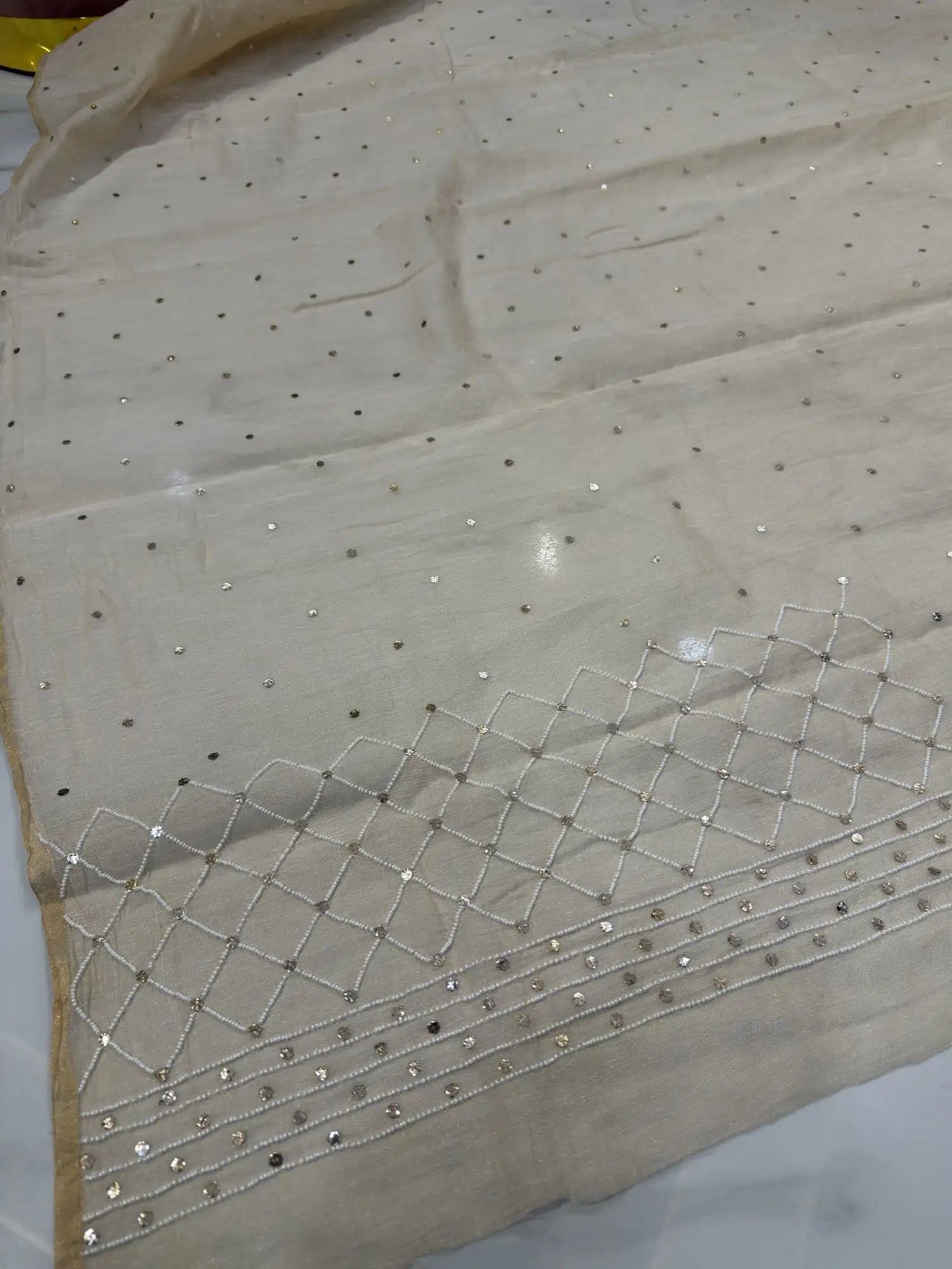 Close-up of handcrafted Mukaish and pearl work border on a Pure Tissue Lucknowi lehenga dupatta