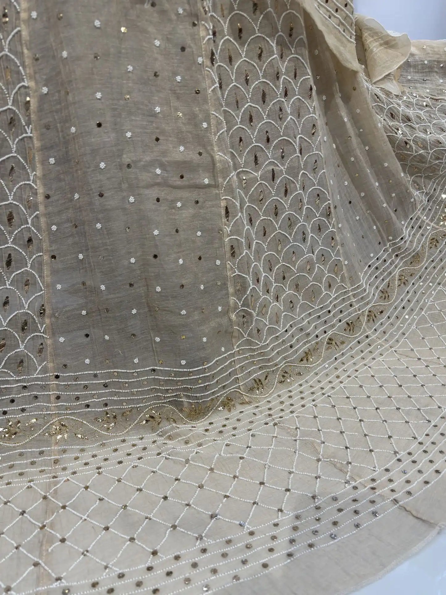 Scalloped embroidery with handcrafted pearl and Mukaish work on a designer Lucknowi lehenga